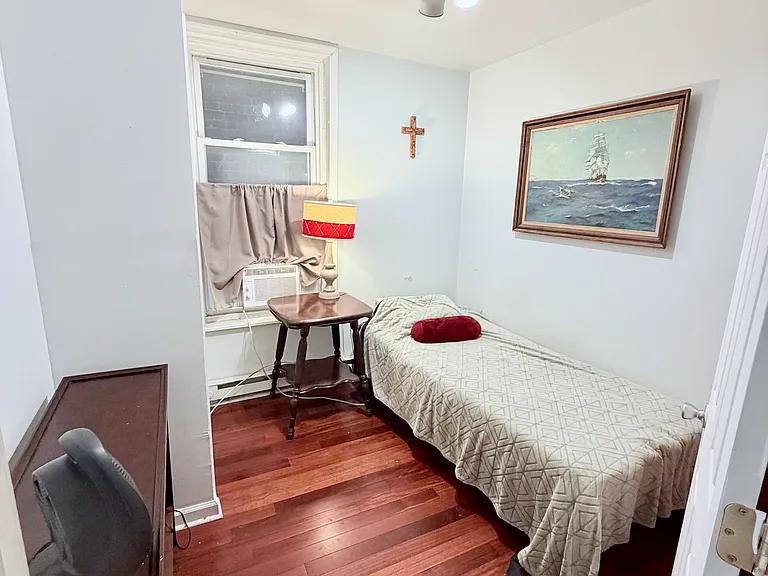 Smaller bedroom with large window and closet