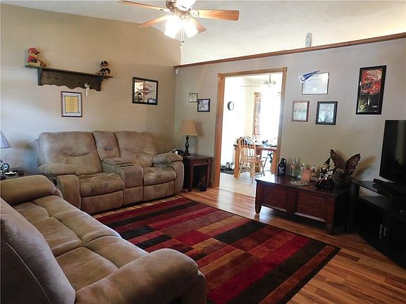 NICE BIG GREAT ROOM OPEN TO DINING AREA.  SO MUCH DAYLIGHT COMES IN THROUGH THE FRONT WINDOWS AND THE SLIDING GLASS DOOR IN THE 