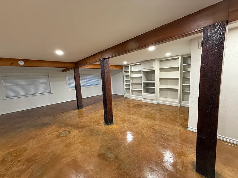 Large Family Room with Built-In Bookshelves and Laundry Room