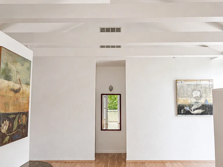 View from the front door. Hall in the back leads to the bathroom on the left and the bedroom on the right.