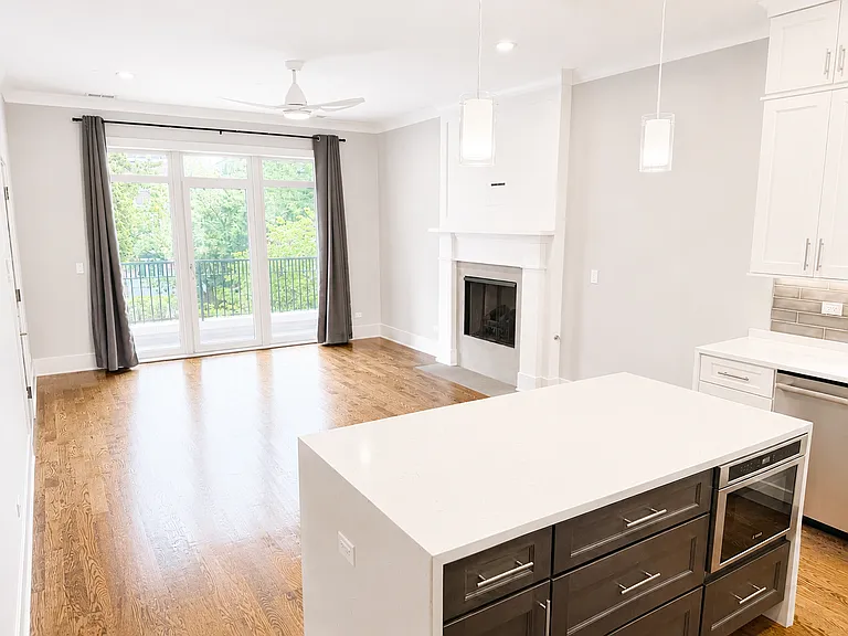 Kitchen looking to Living Room with fireplace and outdoor terrace