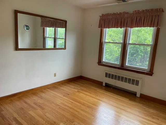 each bedroom has lots of windows and gleaming hardwood floors