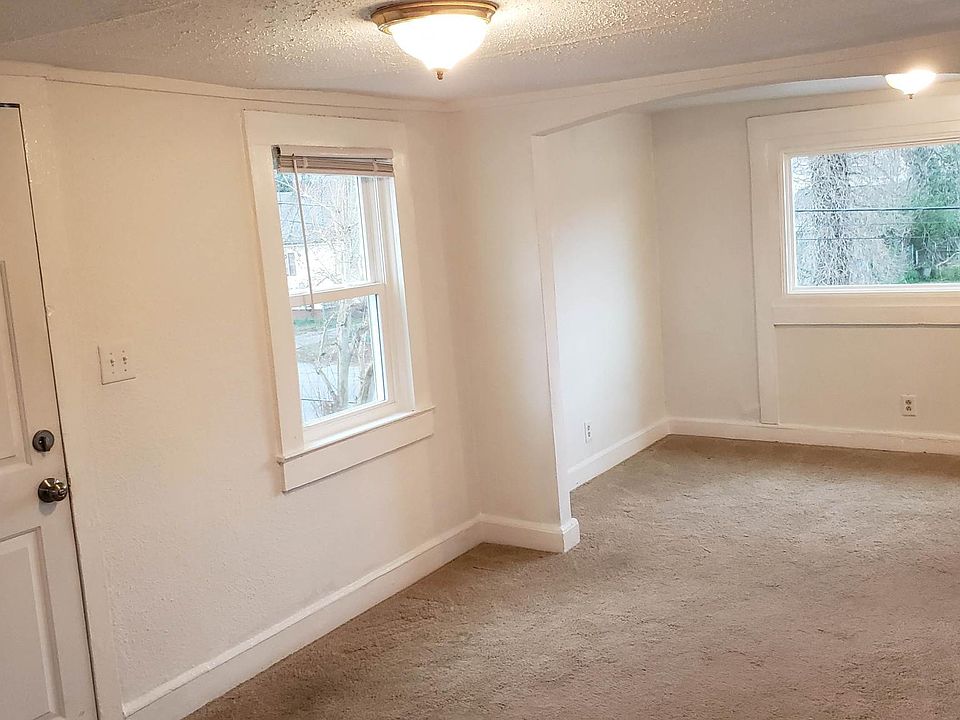 Living room and dining room. Lots of natural light. Apartment has low ceilings.