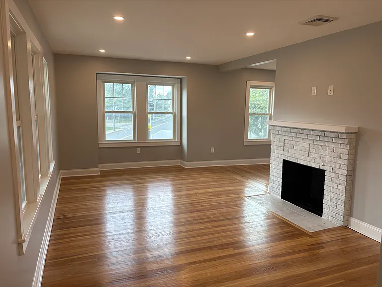 Living Room - Refinished hardwood floors, new insulation, new doors, new windows, new sheetrock, and new electrical.