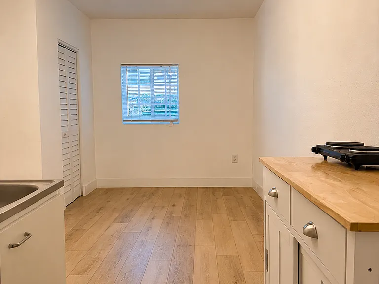 Kitchenette with an open view into the main living and sleeping area.