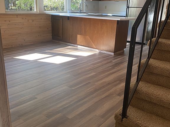Looking into the kitchen. Stairs go to the loft that overlooks the living room space.