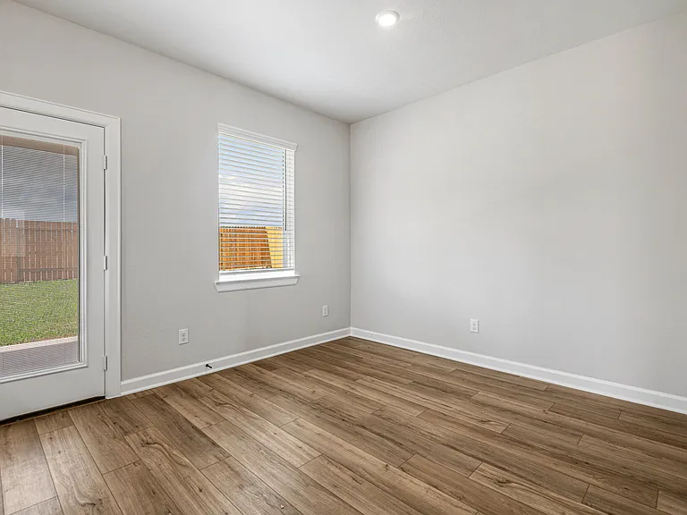 The dining room with a door to the backyard