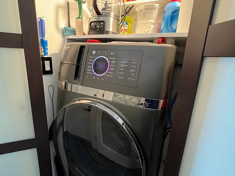 laundry closet with combination washer-dryer