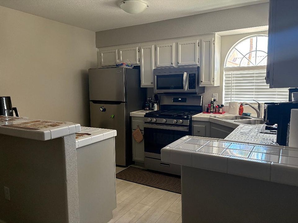 Completly furnished kitchen with refrigerator/ freezer, oven/stove with microwave, keurig coffee pot and dishwasher. Counter has two stools.