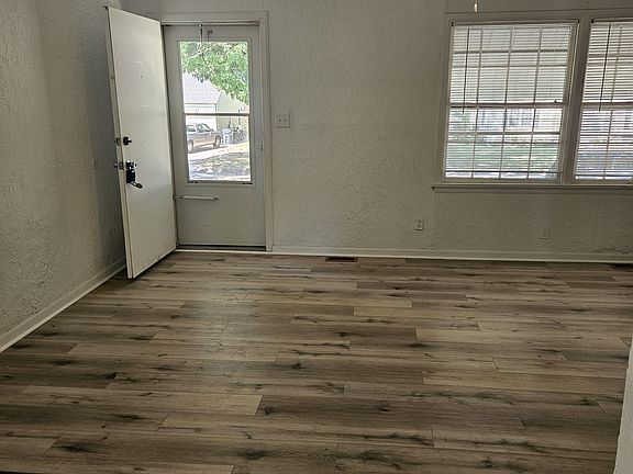 living room area looking toward front door on west of home