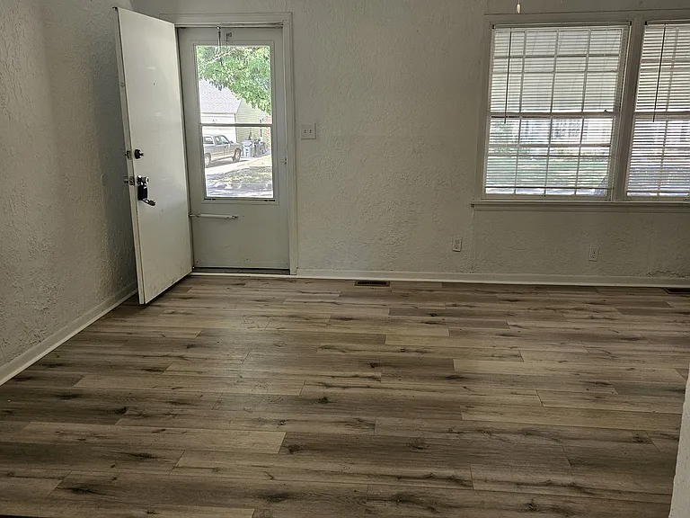 living room area looking toward front door on west of home