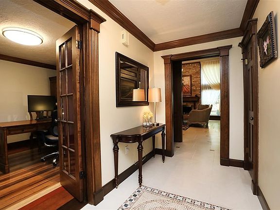 SOPHISTICATED ARCHITECTURAL DETAIL WITH EXTENSIVE MILLWORK - Step inside this totally remodeled home with a handsome study to th