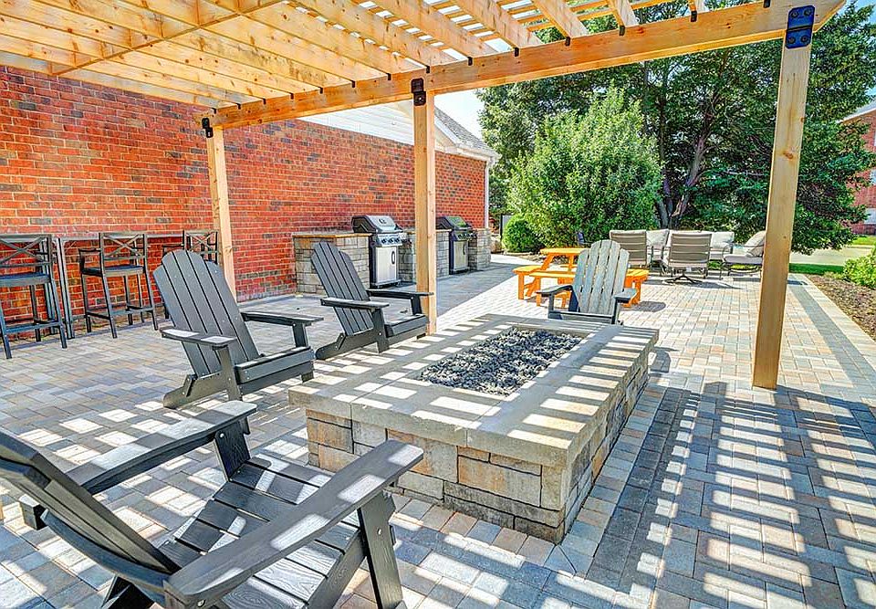 Host your next hangout under the pergola with cozy seating and a gas fire pit perfect for evening relaxation.