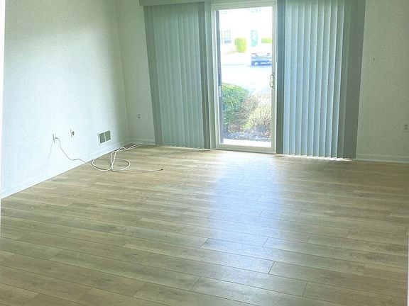 Living room with brand new flooring and brand new Levelor vertical blinds