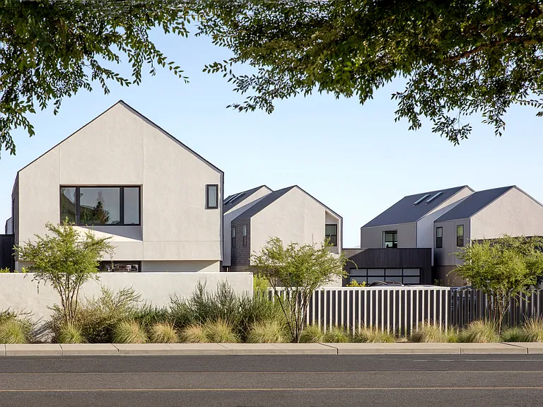 Clean modern forms, private outdoor courts, and low-maintenance desert planting define the quiet, design-forward character of the KARMA community