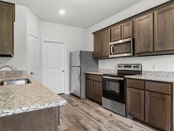 The kitchen of the Cypress has gorgeous wood cabinetry.