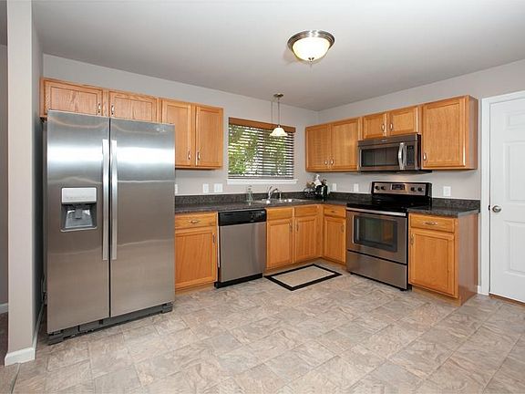 Open kitchen with stainless appliances, pantry and good counter space.