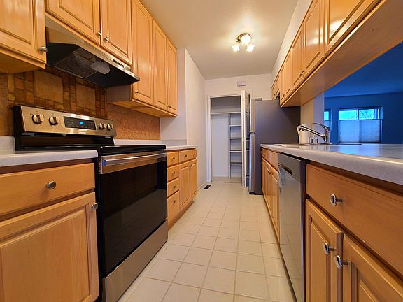 Kitchen and pantry with brand new stainless steel appliances