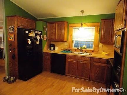 Kitchen : All wood cabinetry, laminate wood flooring, and room for a dining room table