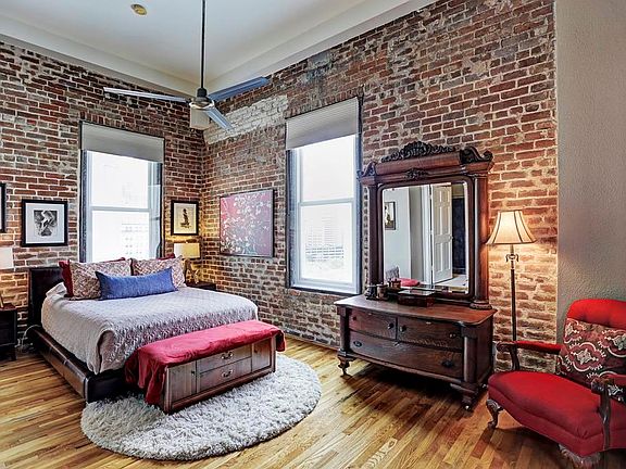 The current owners installed a wall with double pocket doors to provide privacy for the master bedroom from the rest of the loft. Two walls of exposed brick