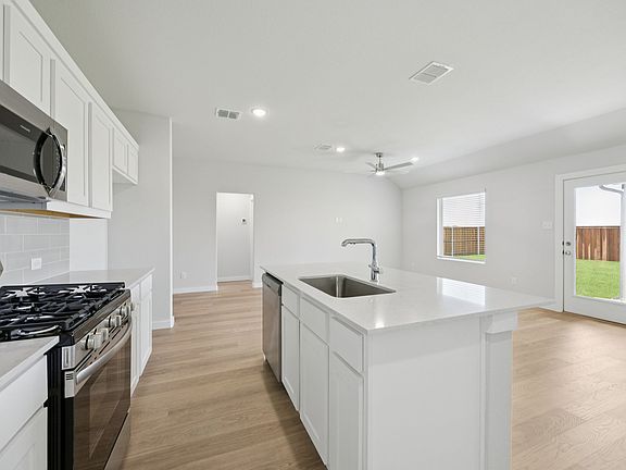 Kitchen in the Hadley home plan by Trophy Signature Homes - REPRESENTATIVE PHOTO