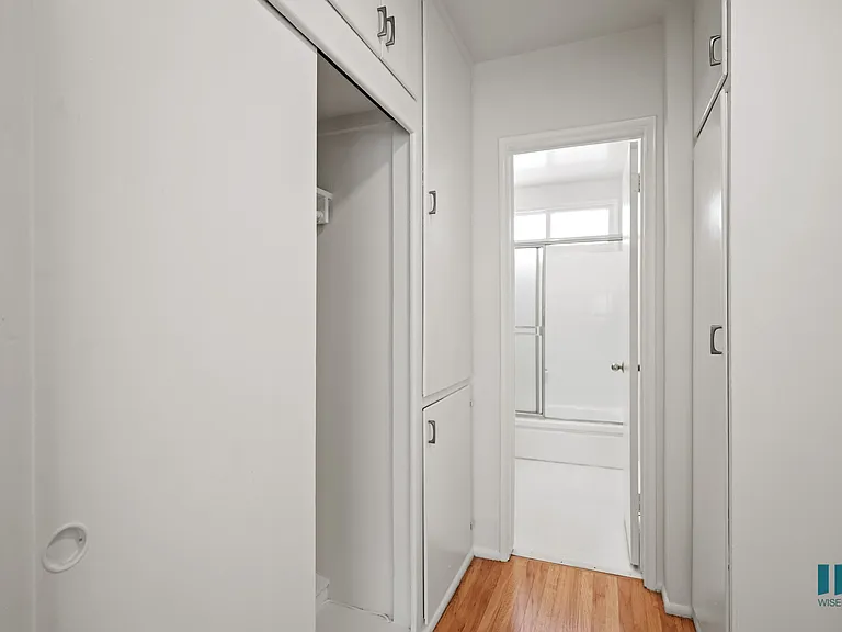 Hallway with Cabinet Storage and Bathroom