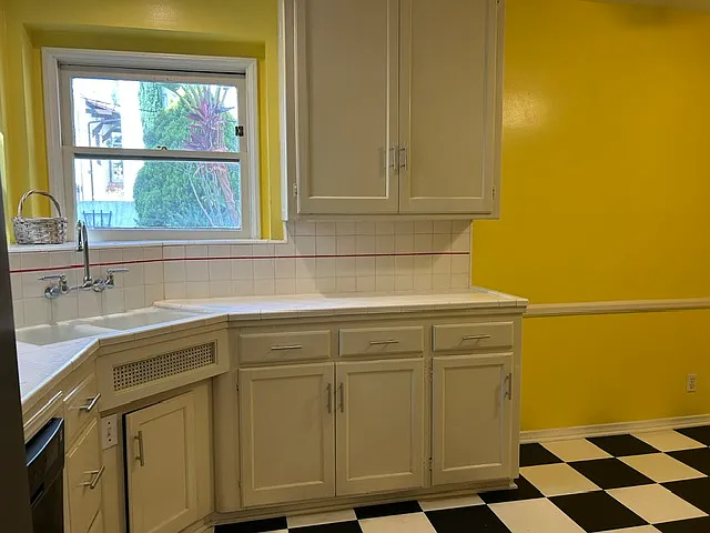 Kitchen enjoys extra counter space and bright with windows looking out to the backyard