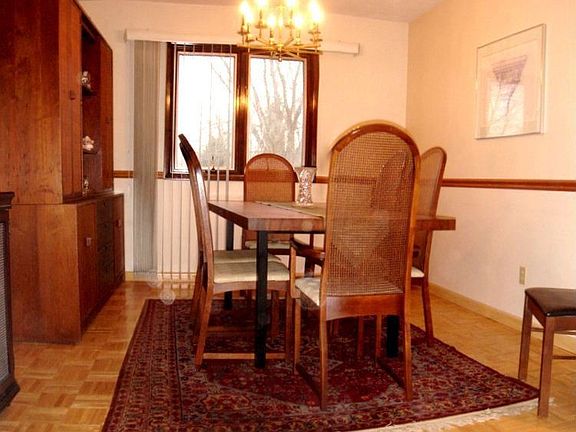 A formal dining room with wood flooring to set off your finest rugs