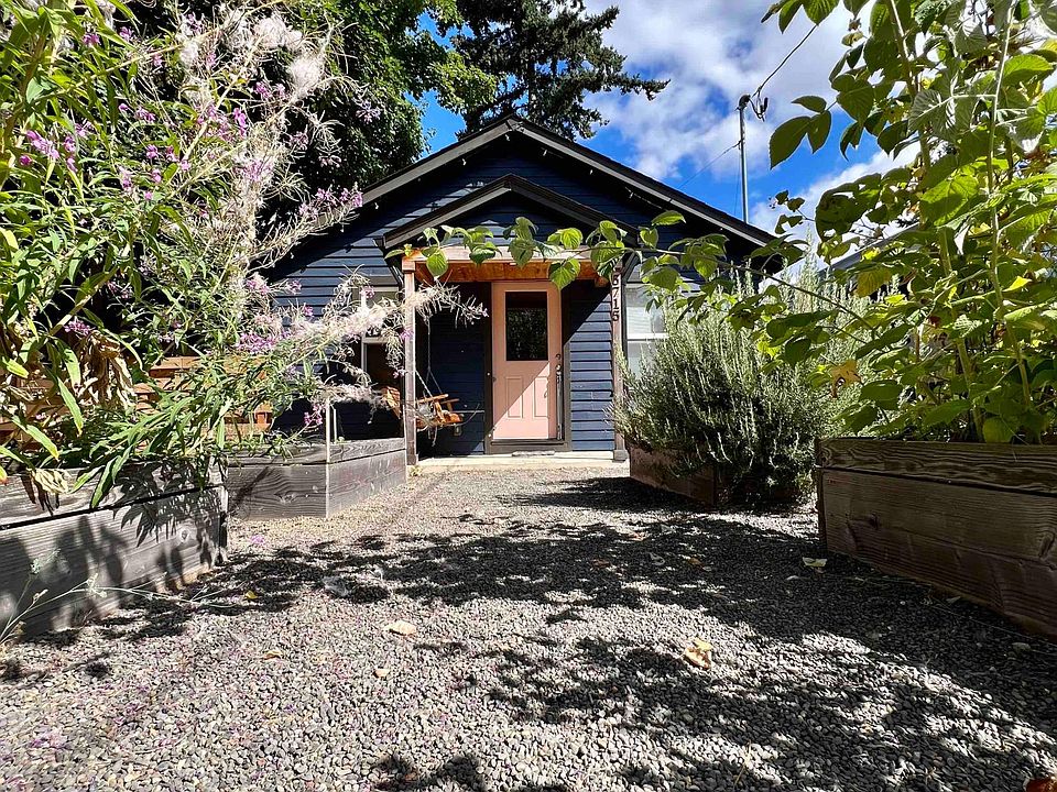 Front of house with wildflowers and raspberries