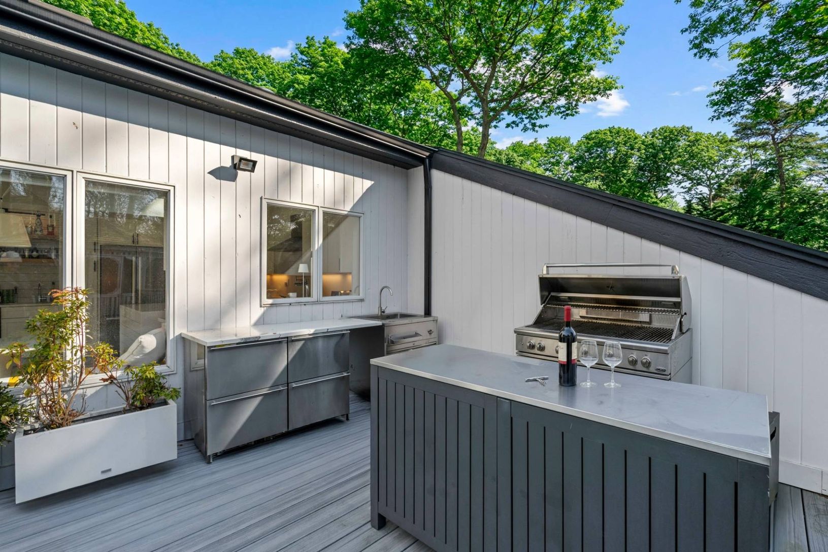 Fully equipped Outdoor Chefs Kitchen and Lounge featuring a grill with custom island and sink