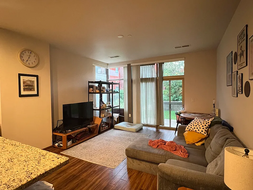 Living room, leads out to patio/plaza area.