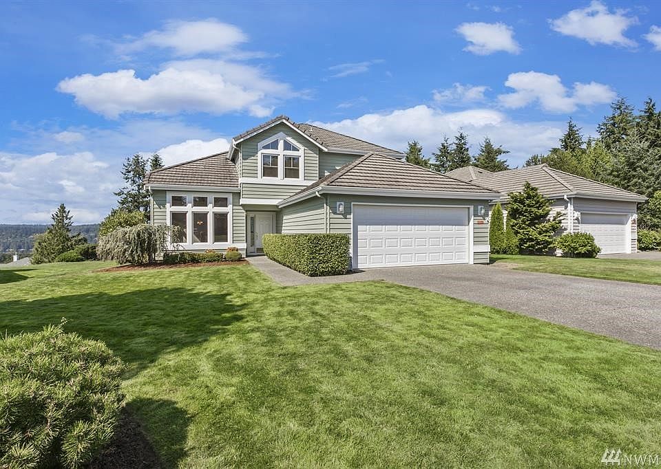 Welcome to this lovingly and beautifully updated 1852sf home perched high above the golf course, and just off Teal Lake Road, minutes to the village, golfing, and all Bay Club amenities!