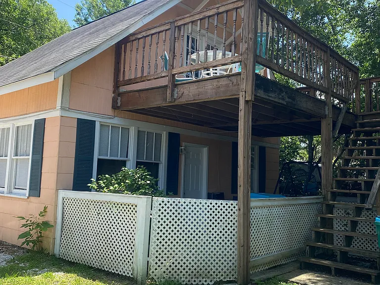 This unit is an upstairs unit with private entrance and it overlooks a huge yard with camellias and live oak trees in a garden-like setting.