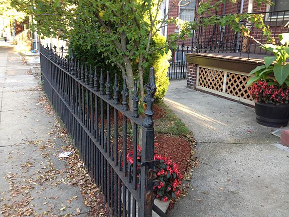 Front area. Historic Iron Fence. Flowers and greenery. Front porch.