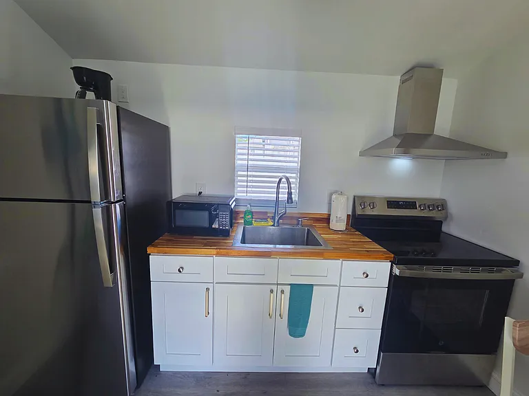 Kitchen includes a cozy dining area and essential amenities