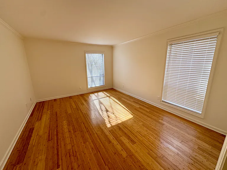 large bedroom accommodates a king bed and one or two dressers (depending on size), and a small chair
