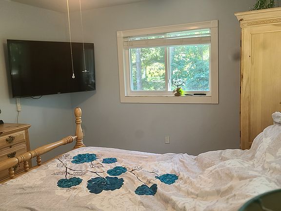 Queen bedroom with large TV