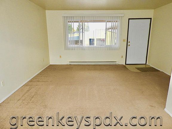 Living room showing large front window and door
