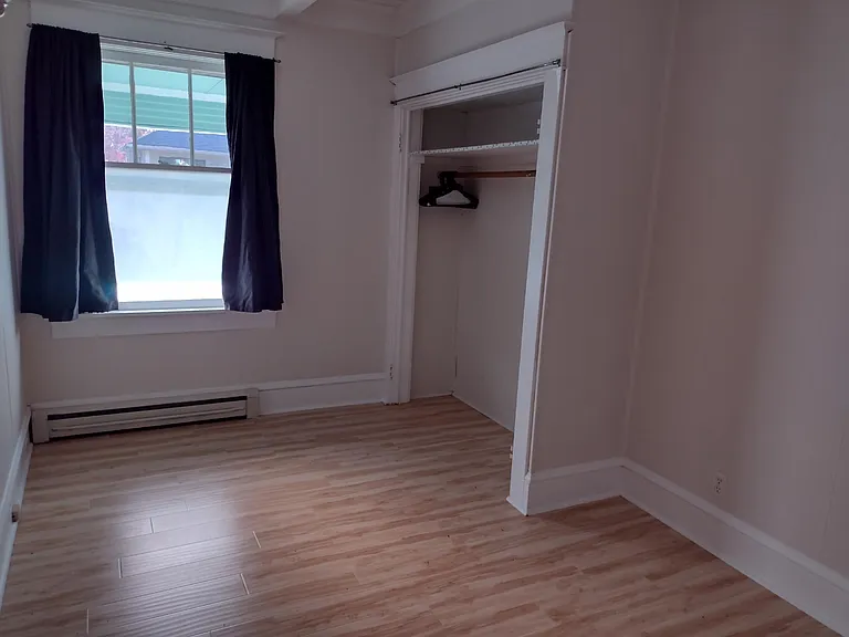 Bedroom with closet, privacy window and room darkening Woolrich curtains.