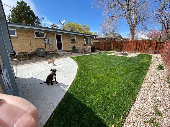 Backyard has a sidewalk that leads to the shed