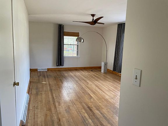 Living room, front door is on the right. Kitchen on the left.