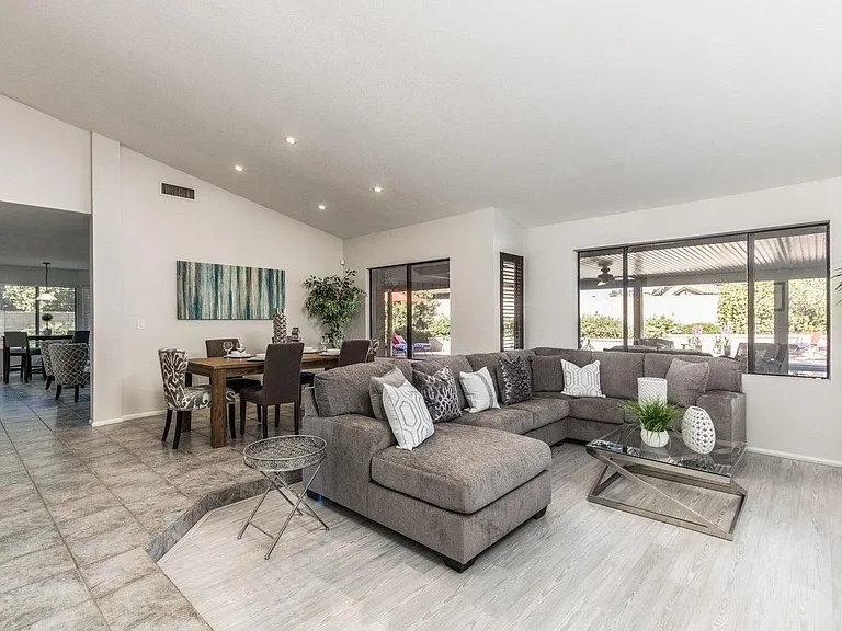 Formal Dining Room and Living Room which is set up with a huge sectional for plenty of people and a massive tv!
