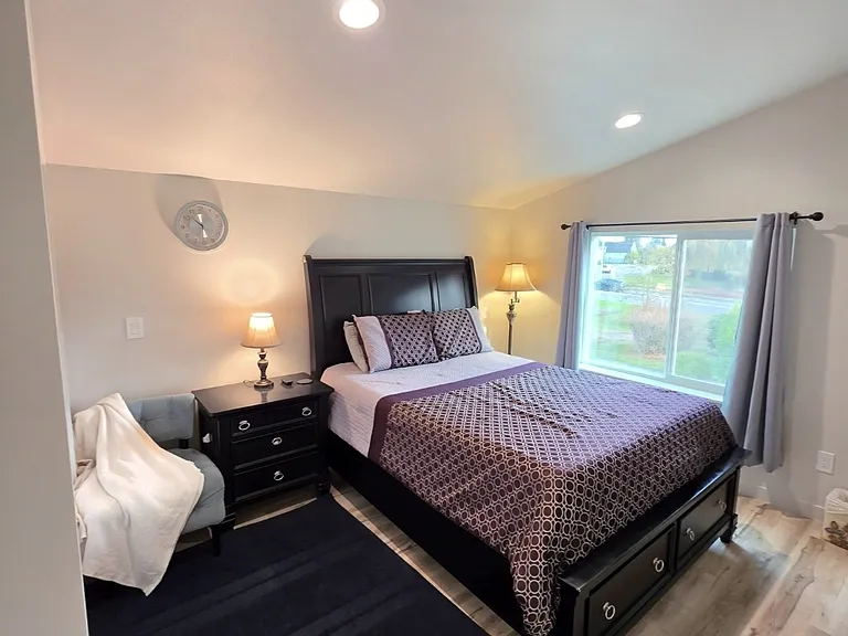 Primary bedroom witih built -in storage in bed. Fully adjustable bed and seating/reading area.