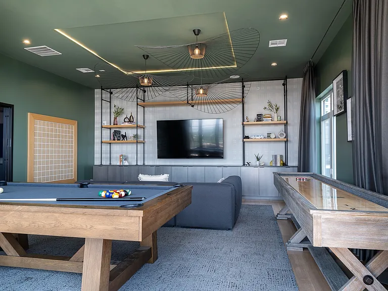 Rooftop game room with shuffleboard, billiards & large TV.