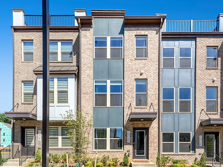 Stunning front exterior showcasing modern design, great curb appeal, and a prime location in the sought-after Quartz District community.