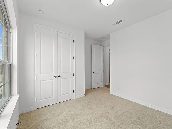An additional view of the second bedroom and closet.