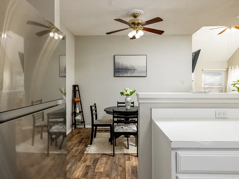 Cozy dining area with a round table for 4, plus additional seating for 2 at the kitchen island_perfect for meals, coffee, or conversation.