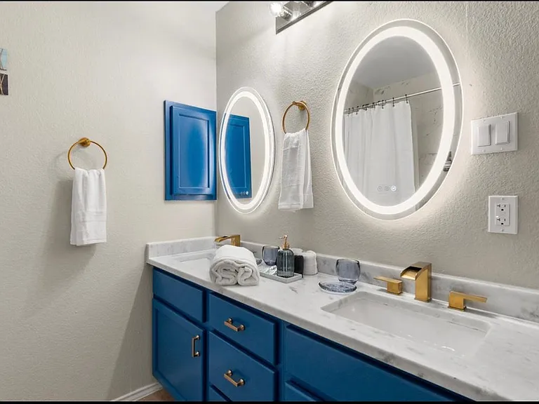 2nd floor full bathroom. 2 sinks, LED mirrors, tub/shower combo with overhead and handheld showers.
