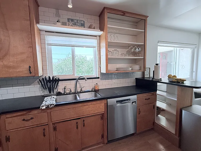 Well-appointed kitchen with dishwasher, refridgerator, and 4 burner gas stove.