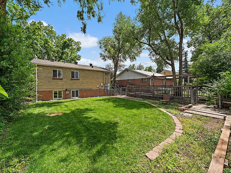 Backyard with grass and planting areas if you like (picture taken from back yard exit gate to alley NW corner)